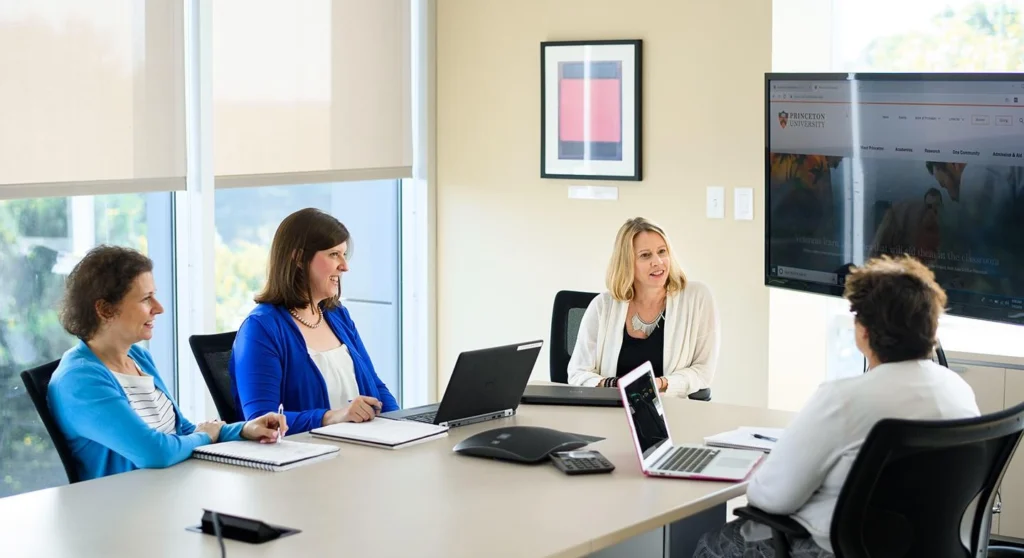 Education administrators using accounting software to manage school finances and budgets.